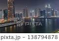 Illuminated skyscrapers and water reflections in Dubai night time-lapse 138794878