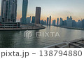 Skyscrapers and water reflections in Dubai day to night transition lapse 138794880