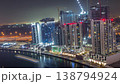 Skyscrapers and construction near Dubai canal all night aerial time-lapse 138794924
