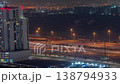 Dubai highway traffic light trails and tall building aerial night time-lapse 138794933
