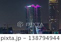 Glowing purple neon roof of curved skyscrapers in Dubai night time-lapse 138794944