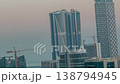 Dubai curved facade skyscrapers day to night transition aerial time-lapse 138794945