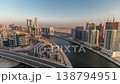 Skyscrapers and highway bridge over Dubai canal aerial evening time-lapse 138794951