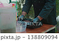 Chef Adding Raisins for Pilaf from Black Bag into Clear Container 138809094