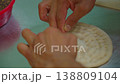 Chef shaping raw Uzbek flatbread, lyepeshka, before baking, close-up 138809104