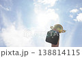 Ambitious Individual Proudly Lifts Elaborate Cup Against Backdrop Of Blue Sky And Soft Clouds 138814115
