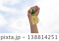 Child Winning Prize Under Bright Sky. Celebrating Young Champion Holding Gleaming Award With Pride 138814251