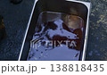 Chef pouring dark pilaf oil from a large ladle into a metal container, close-up 138818435