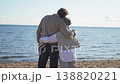Senior mature couple hugging enjoying outdoor recreation walking on beach. Old husband wife embracing with tenderness love enjoying sweet bonding. Grandmother grandfather together. Family moment love 138820221