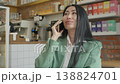 Confident Woman Having Phone Conversation While Sitting In Cozy Urban Cafe 138824701