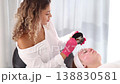 Aesthetician prepares a custom cleansing solution, carefully mixing ingredients for an effective skin treatment. 138830581