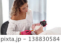 Aesthetician prepares a custom cleansing solution, carefully mixing ingredients for an effective skin treatment. 138830584
