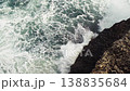 Sea crashing on rocky shore, green water splashing and creating white foam, view from above, slow motion video 138835684
