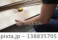 Man installing laminated flooring, fitting wooden tiles, tape measure near 138835705