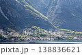 Passenger ferry boat Montenegro Bay Kotor mountains background. Houses line coastline village water landscape during daytime. Travel scenery hills Mediterranean coast sunny weather. 138836621