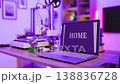 A laptop displays the word HOME next to a 3D printer and filament spools, illuminated by purple ambient lighting 138836728
