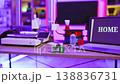 A 3D printer, filament spools, and a laptop displaying the word HOME create a modern crafting environment 138836731
