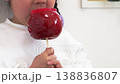 Image of a girl eating a candy apple (5 years old, Japanese) 138836807