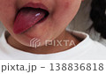 A close-up of a girl's mouth with her long tongue sticking out (5 years old, Japanese). 138836818