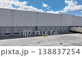 Drone Orbit Shot Left to Right of Commercial Warehouse Loading Dock with Shipping Container. 138837254