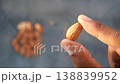 Holding a single almond against a blurred background 138839952