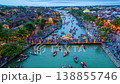 Aerial hyperlapse of traditional wooden boats with lanterns on the Thu Bon River and crowds walking 138855746