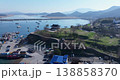 High-res aerial view of Ocheon Port in Boryeong, South Korea, showing boats, sea, and mountains 138858370