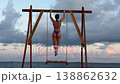 Athletic woman doing pull ups on beach in Maldives 138862632