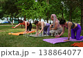 Group of women ending yoga class stretching and playing with kids on mats in summer park. Ending, yoga, stretching, kids, playing, mats, park. 138864077
