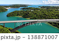 Aerial footage of the Warumi Bridge in Okinawa, moving sideways, showing the emerald green sea and the bridge. 138871007