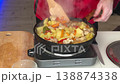 White Male Plating Steaming Skillet Potatoes Into Blue Ceramic Bowl, Wooden Spatula Transfer, Thick Steam 138874338