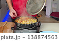 Cooking With Potatoes. Homestyle Kitchen Scene With Steaming Potatoes Transferred To Ceramic Bowl 138874563