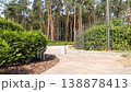 A decorative fir flowerbed near the entrance to the city park, enclosed by a metal fence. Panoramic video of the city botanical garden in 4K resolution 138878413