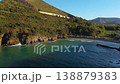 Aerial view of Dicido beach in Miono, Cantabria, showing waves breaking along curved shoreline 138879383