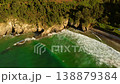 Aerial view of Dicido beach in Miono, Cantabria, showing waves breaking along curved shoreline 138879384