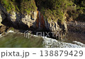 Aerial drone pullback of waterfall flowing into the sea at Dicido beach. Scenic coastal landscape 138879429