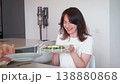 Woman serving plate with salad and grilled salmon 138880868