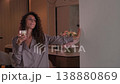 Young woman in pajamas smiling and holding coffee 138880869