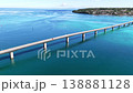 Aerial footage of Okinawa's Kouri Bridge and Kouri Island, showing the emerald green sea and the bridge. 138881128