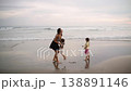Family having fun together on the beach at sunset 138891146