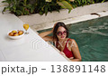 Close-up of woman swimming and relaxing in villa pool 138891148