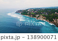 Aerial view of tropical island coastline with ocean waves crashing 138900071
