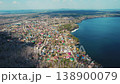 Aerial view of a village on the shore of a lake 138900079