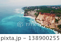 Aerial flight over stunning rocky cliffs and turquoise ocean waves 138900255