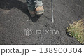 Slow motion of a hiker walking on dark volcanic terrain, Etna Volcano, 4k 138900304
