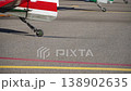 Small wheel under tail of light aircraft on asphalt parking at aerodrome. Wheel part of air transport necessary for safe landing. 138902635