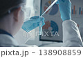 A laboratory professional analyzes a blue solution in a test tube, surrounded by scientific glassware and equipment. The scene highlights precision, innovation, and scientific progress in research 138908859