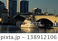 Drawbridge closing over water with boats and evening light 138912106