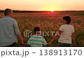 Parents son child walk holding hands, meadow sunset. Family go in nature park. Happy family dad mom son in nature. Concept family recreation travel in nature. Active family. People relax together 138913170