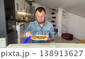 Relaxed Man In Casual Attire Enjoying Simple Homecooked Dinner In Contemporary Kitchen Ambiance 138913627